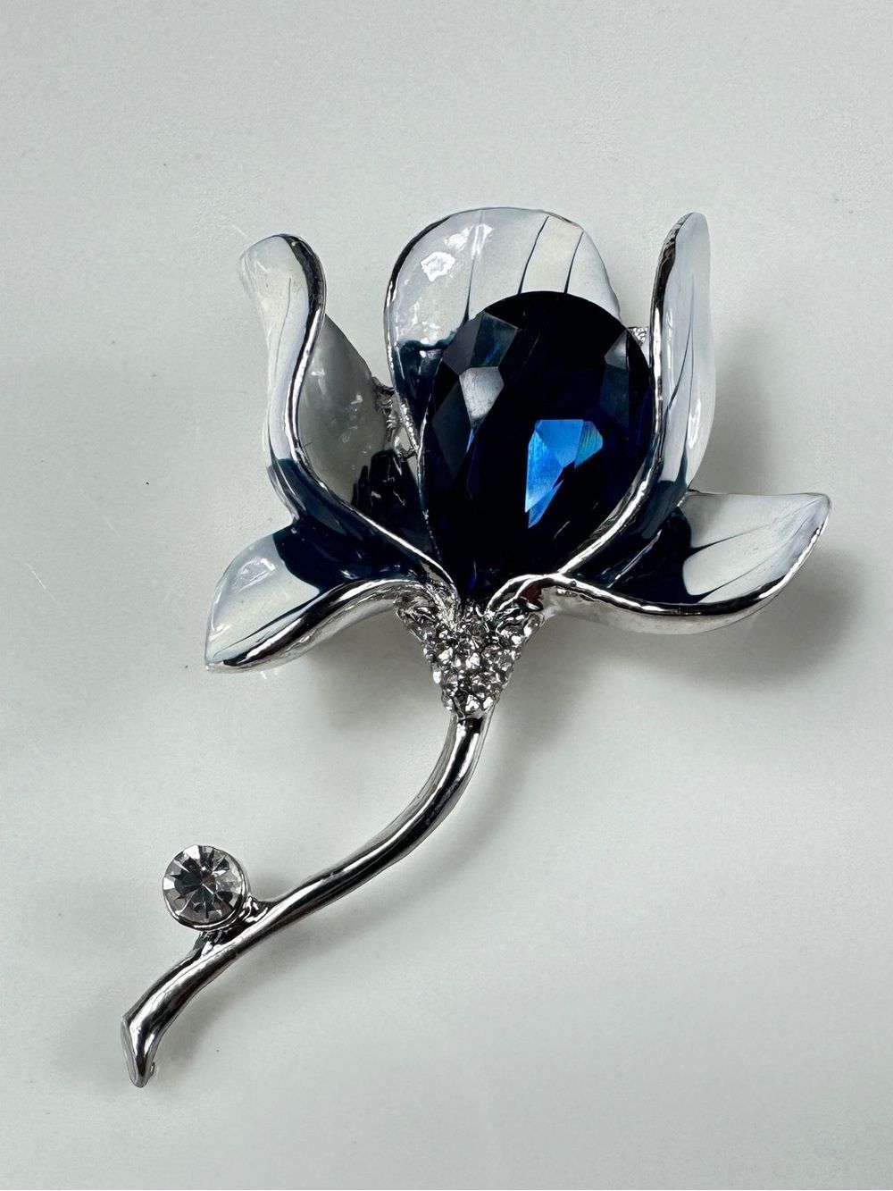 Silver Floral Brooch with Deep Blue Faceted Crystal